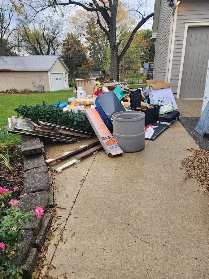 Dumpster being loaded with debris for Commercial Dumpster Rental in Davenport